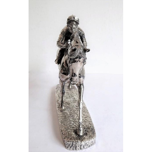 145 - A hallmarked silver (filled) late 20th/early 21st century model of a jockey and racehorse in full fl... 