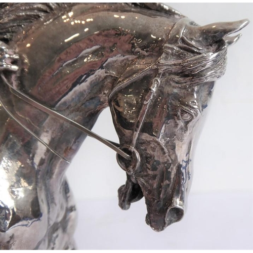 145 - A hallmarked silver (filled) late 20th/early 21st century model of a jockey and racehorse in full fl... 