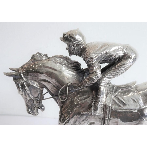 145 - A hallmarked silver (filled) late 20th/early 21st century model of a jockey and racehorse in full fl... 