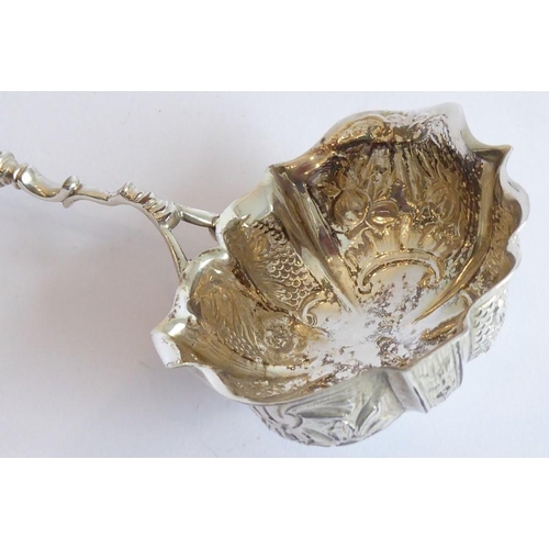 149 - A mid-18th century silver and fruitwood toddy ladle; the lobed bowl embossed with floral, fruiting, ... 