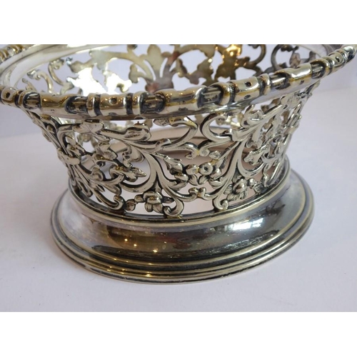 152 - A cut-glass bowl within an ornate silver-plated mount headed with four female mask and ring heads ab... 