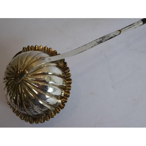 157 - An early 19th century silver and whalebone toddy ladle; the scallop-edged bowl to the monogrammed sh... 