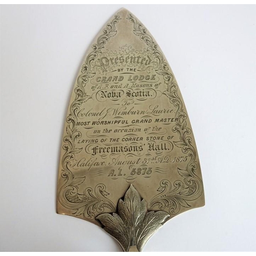 180 - A late 19th century silver and ivory-handled presentation trowel; the script within the foliate scro... 