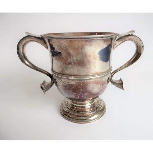 186 - A hallmarked silver two-handled loving cup; the handle terminals modelled as hearts, raised on sprea... 