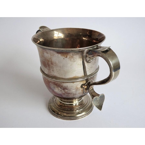 186 - A hallmarked silver two-handled loving cup; the handle terminals modelled as hearts, raised on sprea... 