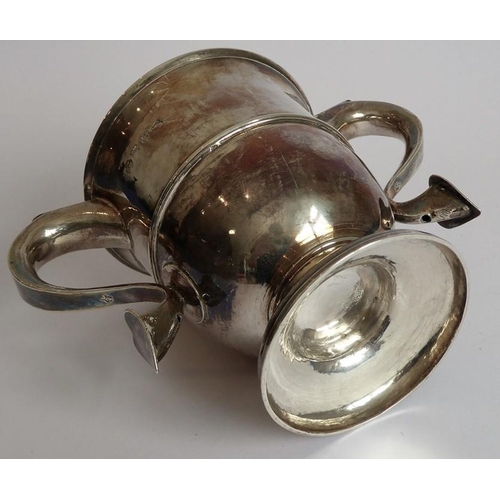 186 - A hallmarked silver two-handled loving cup; the handle terminals modelled as hearts, raised on sprea... 