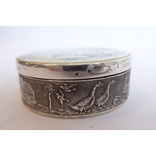 187 - A circular silver and enamel box; the enamelled lid depicting Winnie the Pooh, Piglet, Tigger and Ee... 