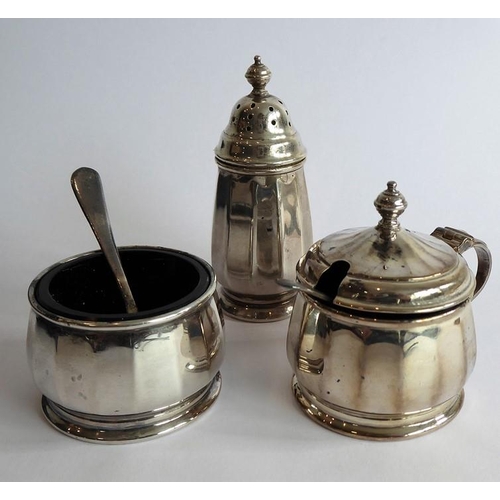 194 - A hallmarked silver cruet set: pepperette, salt and lidded mustard with blue-glass liners, and two s... 