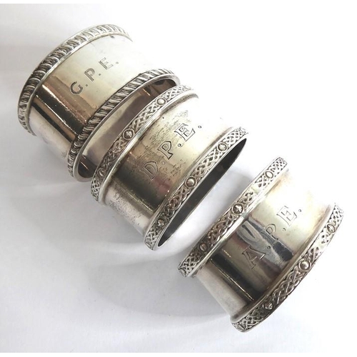 201 - Six hallmarked silver napkin rings: a pair of heavy hallmarked examples with Celtic bands, another o... 