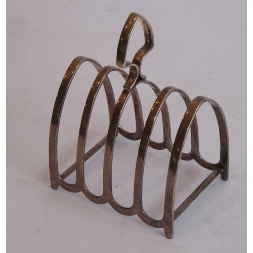 203 - A hallmarked silver four-division toast rack of arched form together with a small hallmarked silver ... 