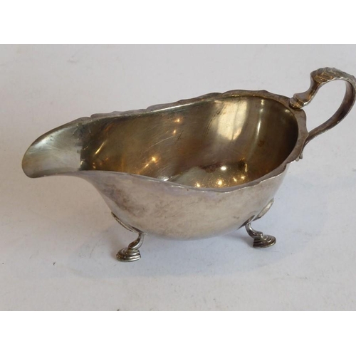 203 - A hallmarked silver four-division toast rack of arched form together with a small hallmarked silver ... 