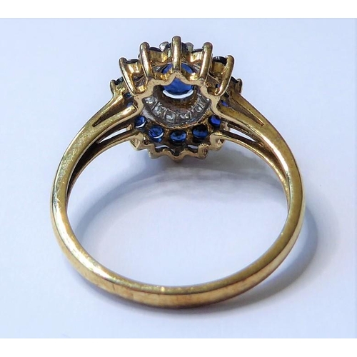 205 - A sapphire and diamond set cluster ring; the central oval mixed-cut sapphire above a surround of bri... 