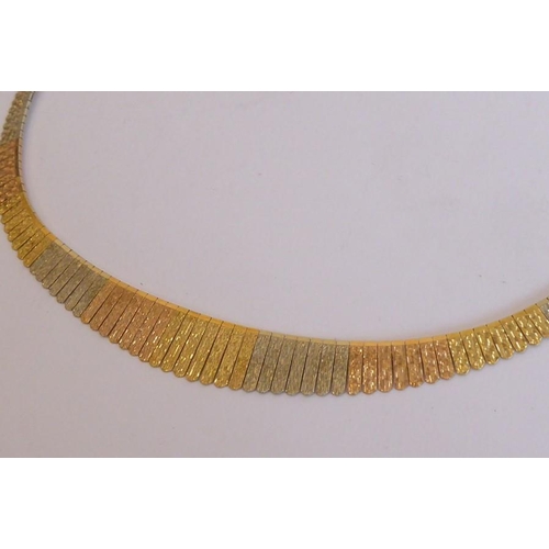 208 - A three-colour collar necklace; the articulated textured bars in yellow, white and red sections, con... 