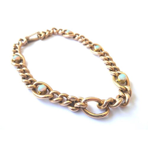 210 - A 15 carat yellow gold curb and oval link chain bracelet collet-set at intervals with circular opal ... 