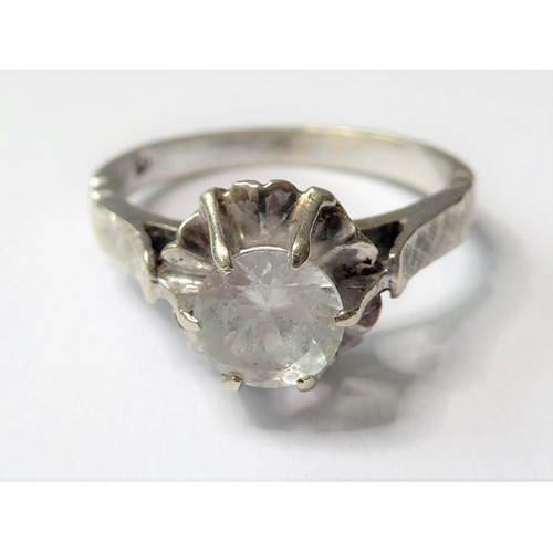 214 - A white stone ring, the circular-cut stone coronet-set above the textured shoulders and plain shank ... 