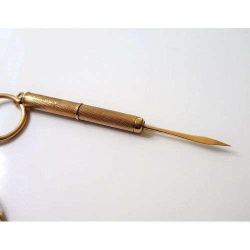 216 - A 9-carat yellow-gold-cased propelling tooth pick; Birmingham hallmark, suspended from a 9-carat yel... 