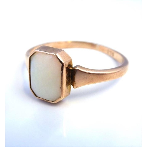 220 - An opal ring, the rectangular cut-cornered opan collet-set to the plain tapering shank stamped '9CT'... 