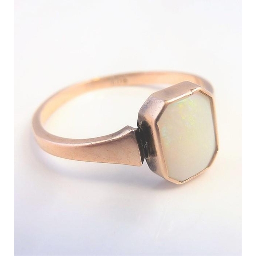 220 - An opal ring, the rectangular cut-cornered opan collet-set to the plain tapering shank stamped '9CT'... 