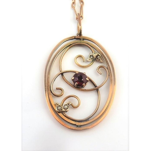 226 - A gold pendant set with a garnet and pearls on a Victorian rose-gold chain