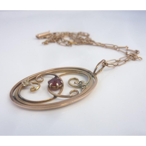 226 - A gold pendant set with a garnet and pearls on a Victorian rose-gold chain