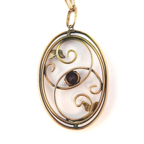 226 - A gold pendant set with a garnet and pearls on a Victorian rose-gold chain