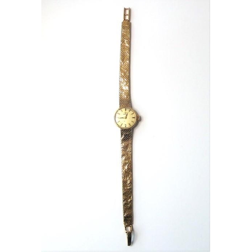 229 - A lady's 9-carat yellow-gold wristwatch by Omega; the champagne-coloured dial with baton markers sig... 