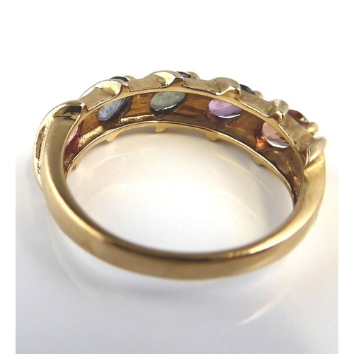 231 - A gem-set 9 carat yellow gold ring the top section set with five pastel-coloured navette-shaped sapp... 