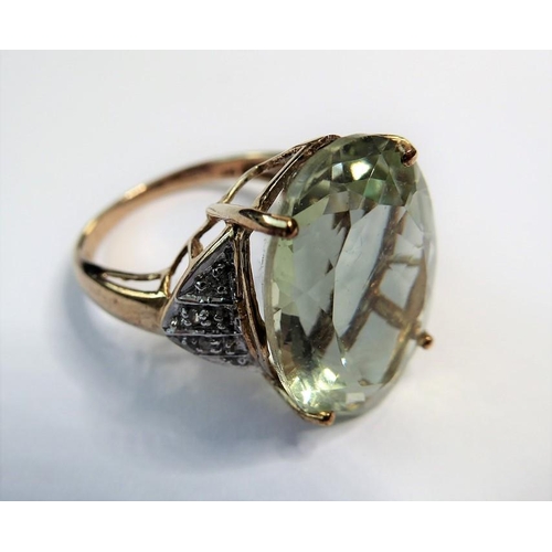 235 - A pale green (probably beryl) ring, the oval mixed-cut stone claw-set to the 9 carat yellow and whit... 