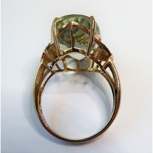 235 - A pale green (probably beryl) ring, the oval mixed-cut stone claw-set to the 9 carat yellow and whit... 