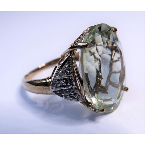 235 - A pale green (probably beryl) ring, the oval mixed-cut stone claw-set to the 9 carat yellow and whit... 