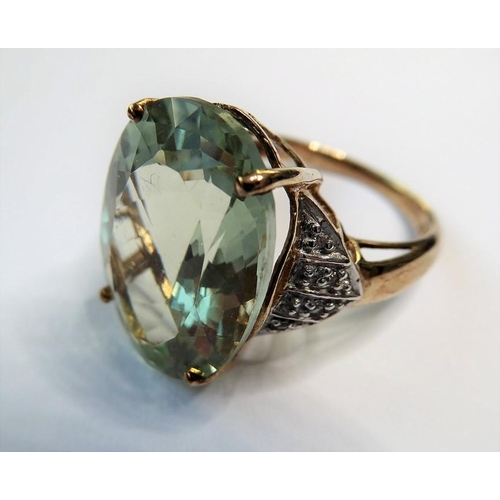 235 - A pale green (probably beryl) ring, the oval mixed-cut stone claw-set to the 9 carat yellow and whit... 