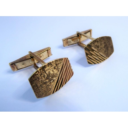 236 - A pair of 9 carat yellow gold tonneau plaque cufflinks with engraved decoration, swivel topedo backs... 