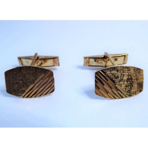 236 - A pair of 9 carat yellow gold tonneau plaque cufflinks with engraved decoration, swivel topedo backs... 