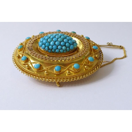 237 - A mid-19th century yellow gold and turquoise brooch, circa 1840, the central oval dome set with a ha... 