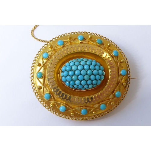 237 - A mid-19th century yellow gold and turquoise brooch, circa 1840, the central oval dome set with a ha... 