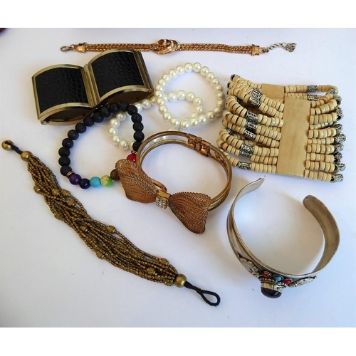 239 - A selection of mostly costume jewellery and bijouterie to include necklaces, bangles, beads and a nu... 