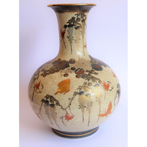 25 - An early 20th century Japanese Satsuma vase of bottle form; hand gilded and decorated with various b... 