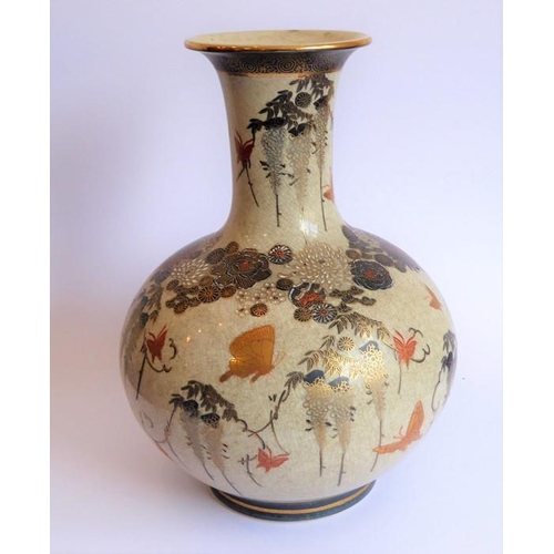 25 - An early 20th century Japanese Satsuma vase of bottle form; hand gilded and decorated with various b... 