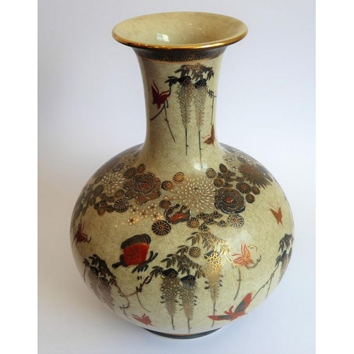 25 - An early 20th century Japanese Satsuma vase of bottle form; hand gilded and decorated with various b... 