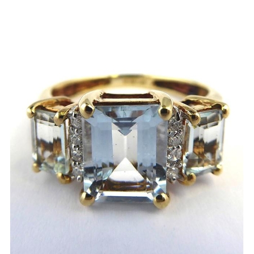 256 - An aquamarine and diamond-set ring; the three graduated rectangular aquamarines each separated by a ... 