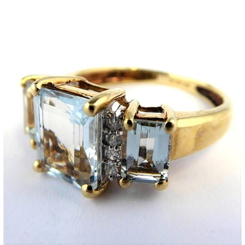 256 - An aquamarine and diamond-set ring; the three graduated rectangular aquamarines each separated by a ... 