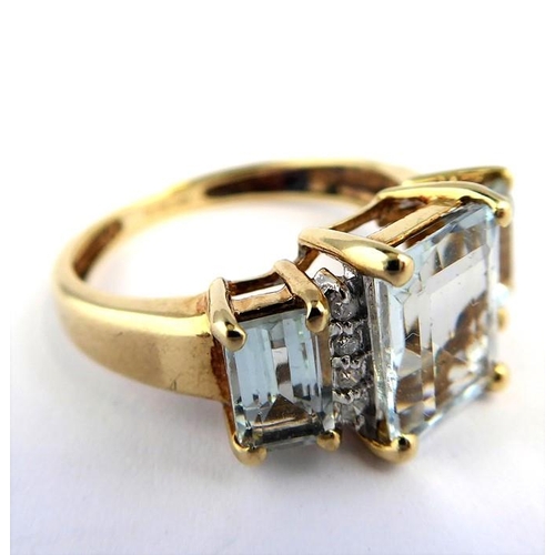 256 - An aquamarine and diamond-set ring; the three graduated rectangular aquamarines each separated by a ... 