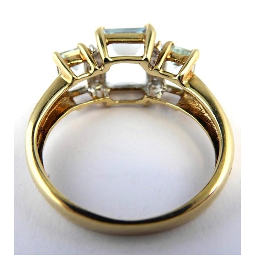 256 - An aquamarine and diamond-set ring; the three graduated rectangular aquamarines each separated by a ... 