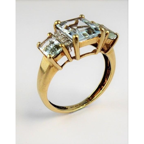 256 - An aquamarine and diamond-set ring; the three graduated rectangular aquamarines each separated by a ... 