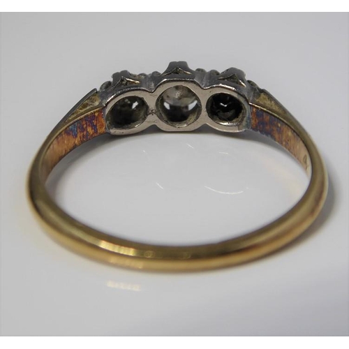 259 - A three stone brilliant-cut diamond ring to the plain shank stamped '18CT PLAT', size J (gross weigh... 