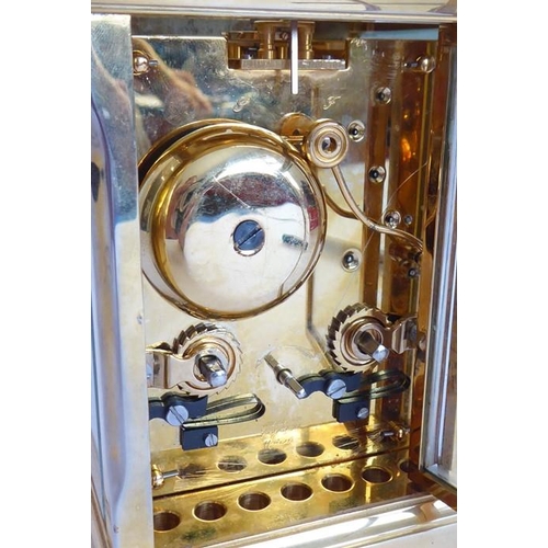 274 - A good modern gilt metal and glass sided carriage clock; the white enamel dial with Roman numerals a... 