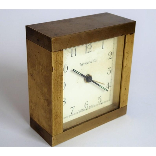 286 - A heavy (probably gilt-bronze) alarm clock; the square white dial signed 'Tiffany & Co.' (9cm high)