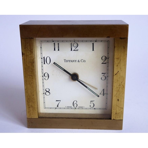 286 - A heavy (probably gilt-bronze) alarm clock; the square white dial signed 'Tiffany & Co.' (9cm high)