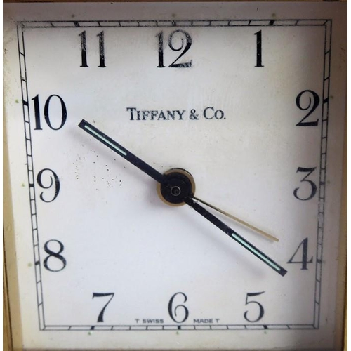 286 - A heavy (probably gilt-bronze) alarm clock; the square white dial signed 'Tiffany & Co.' (9cm high)