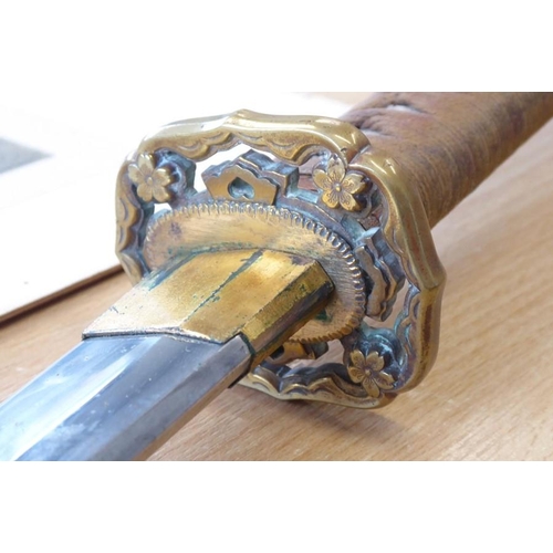 305 - A Japanese Katana; the tightly bound shagreen handle terminating in a patinated copper end decorated... 